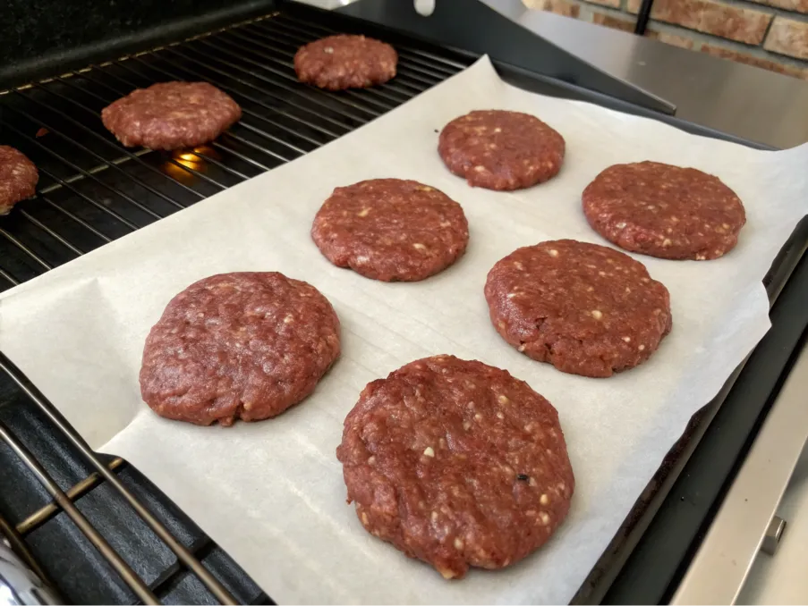 Freshly formed brisket burger patties on parchment paper.