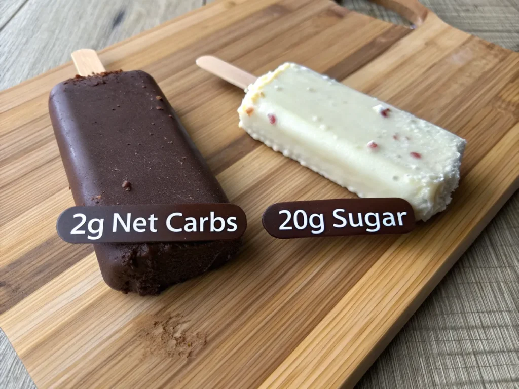 A side-by-side comparison of a traditional ice cream bar and a keto ice cream bar, showing differences in carbs and sugar.